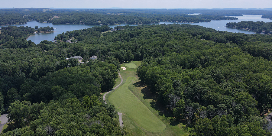 houses, trees, golf course, water
