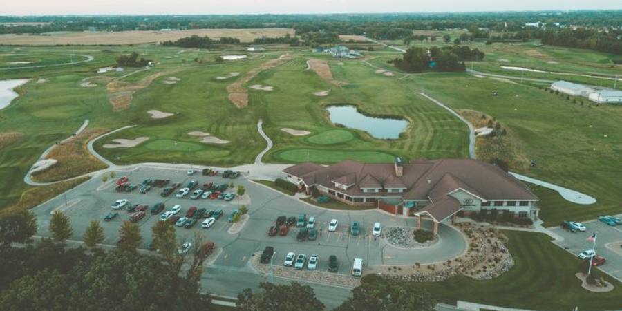 parking lot, building, golf course, water parking lot, building, golf course, water